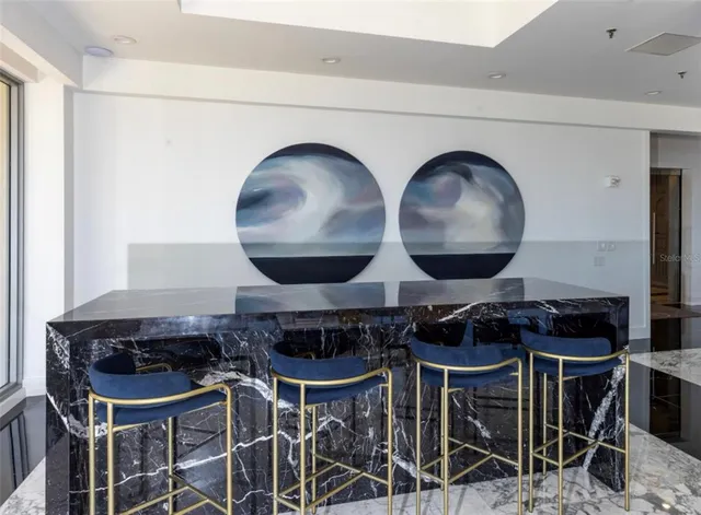 a room with pool table windows and wooden floor