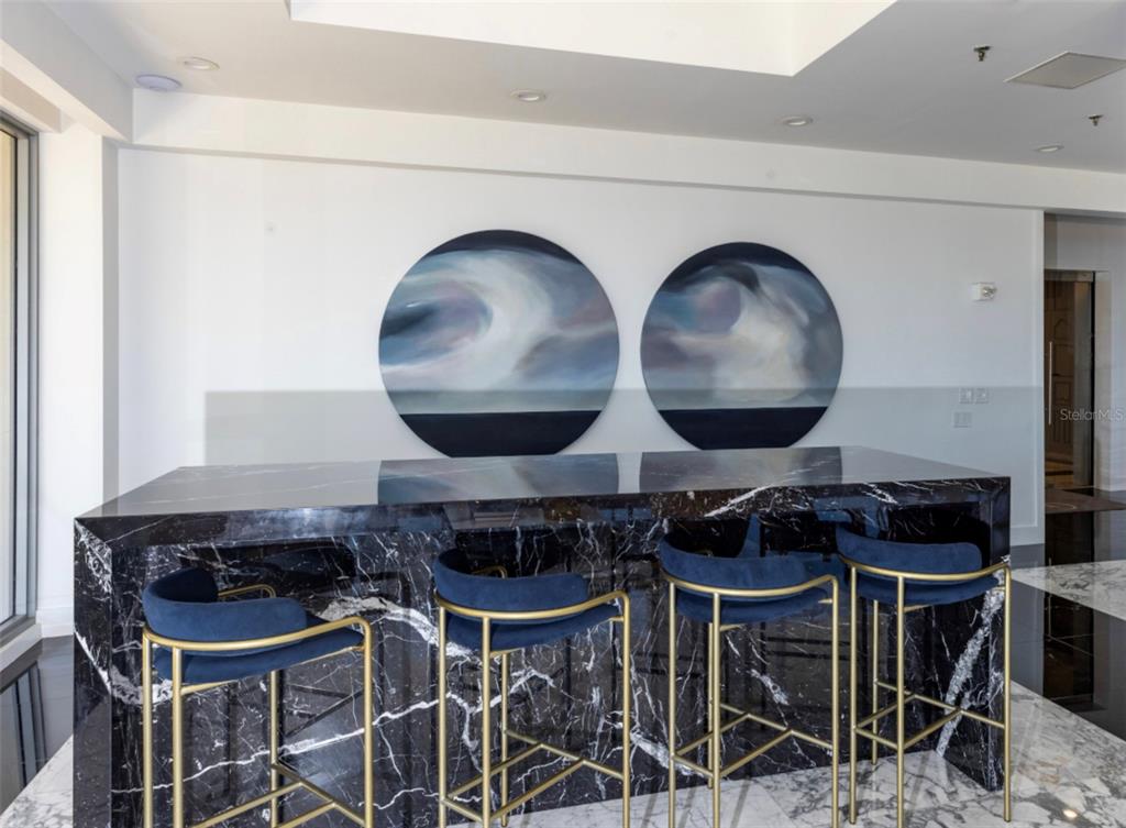 11 Island Avenue, Unit 309 Miami Beach, FL 33139 - Photo 9 of 28 a kitchen with a wooden table and chairs