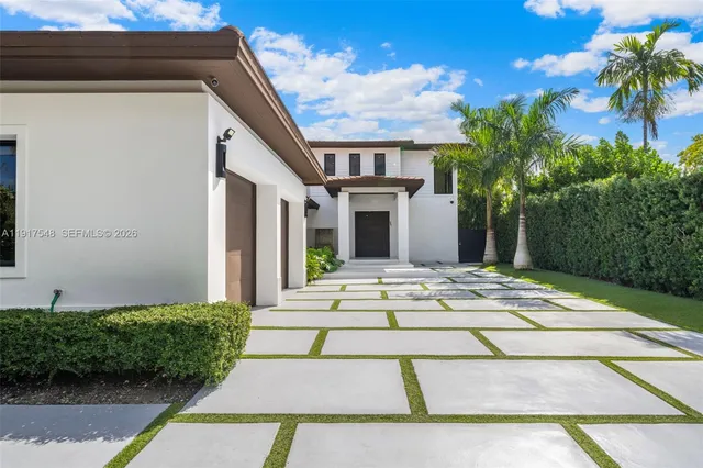 a view of a house with palm trees