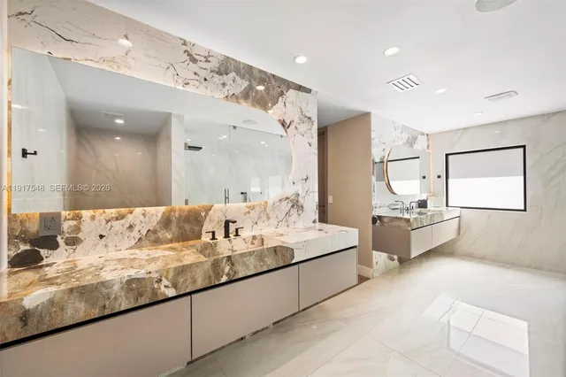 a large white kitchen with a large window