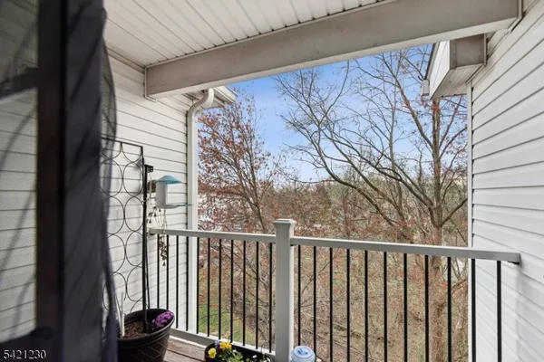 a view of a balcony with wooden fence