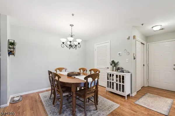 a view of a dining room with furniture and chandelier