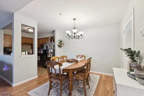 a dining room with furniture potted plants and wooden floor
