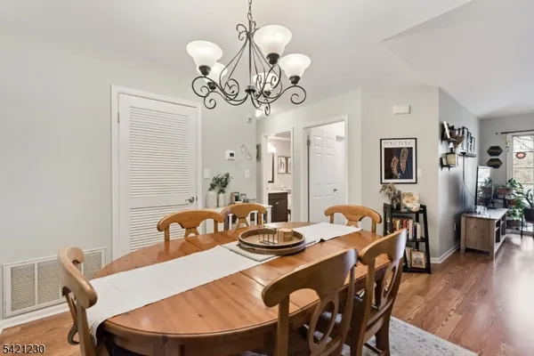 a view of a dining room with furniture wooden floor and chandelier