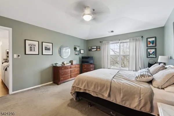 a bedroom with a bed and a dresser with kitchen