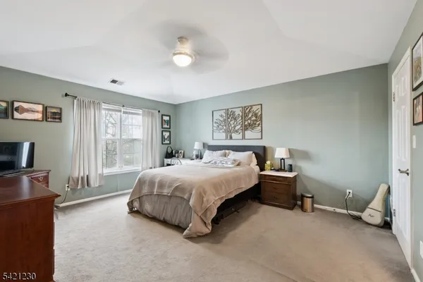 a spacious bedroom with a bed and a couch