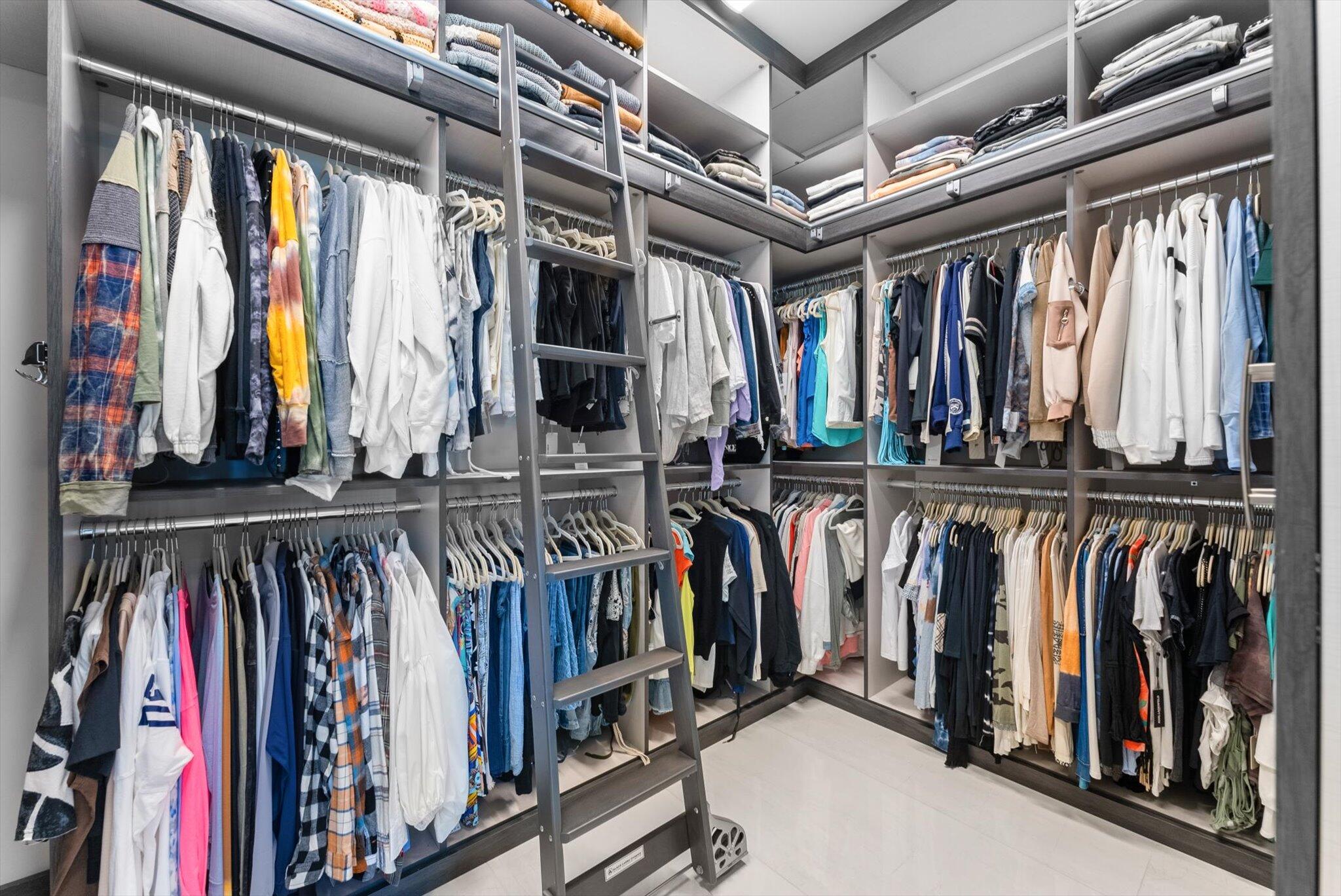 9794 Chianti Classico Terrace Boca Raton, FL 33496 - Photo 74 of 118 a view of walk in closet with clothes and shoes