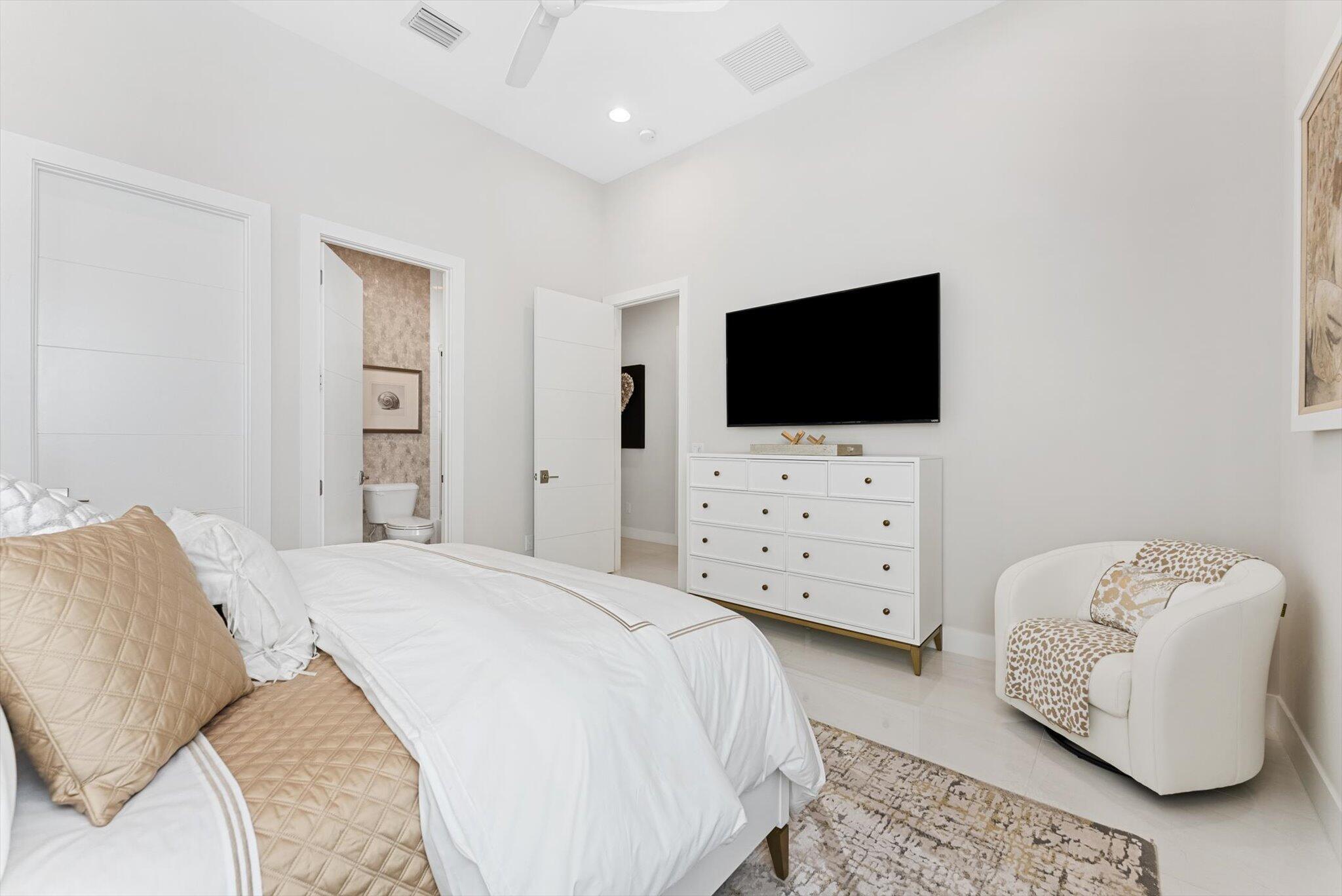 9794 Chianti Classico Terrace Boca Raton, FL 33496 - Photo 89 of 118 a bedroom with a bed and a flat screen tv