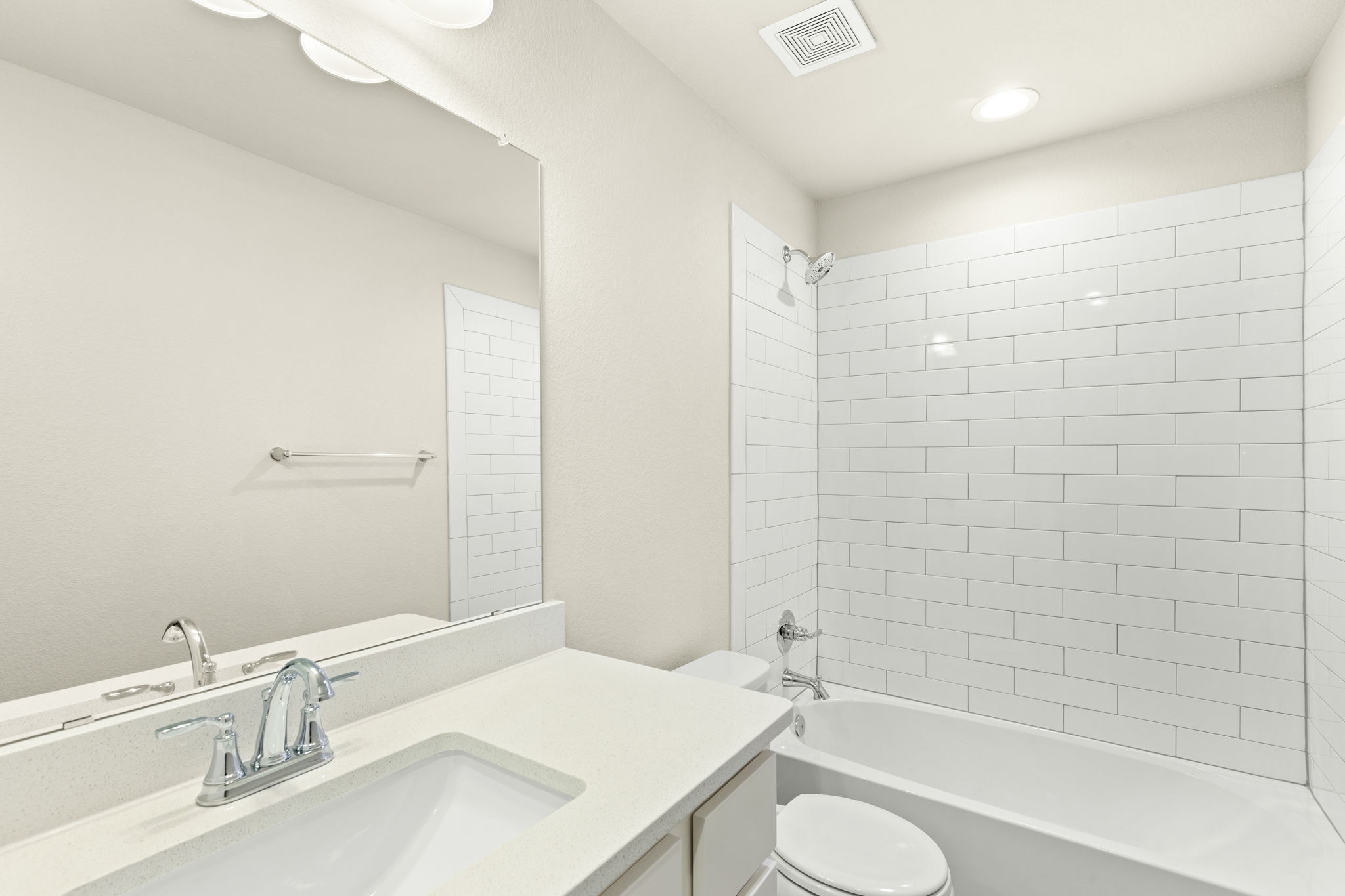 1624 Caballo Blanco Road Austin, TX 78725 - Photo 20 of 27 Crisp subway tile surrounds the soaking tub in this modern bathroom layout.