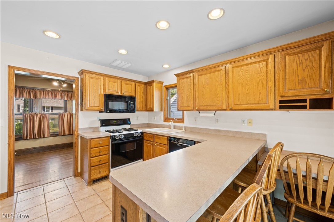 3918 Bluestone Road Cleveland Heights, OH 44121 - Photo 6 of 27 Kitchen featuring light flooring, sink, and black appliances