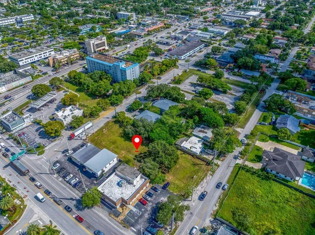 an aerial view of residential houses with outdoor space and street view
