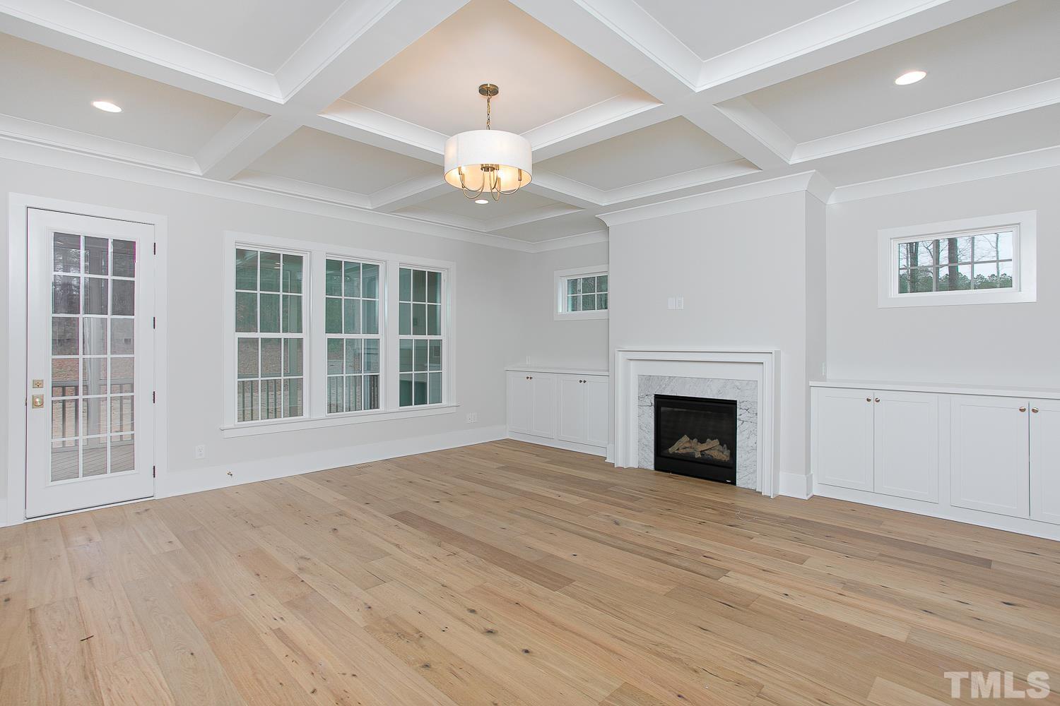 1429 Starry Night Court Raleigh, NC 27613 - Photo 6 of 31 a view of an empty room with wooden floor and a window