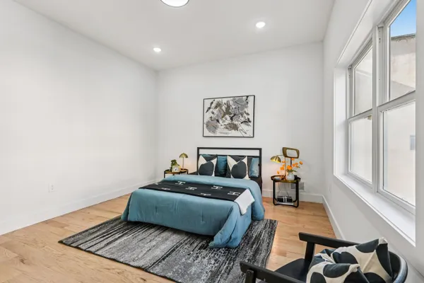 a bedroom with furniture and a window