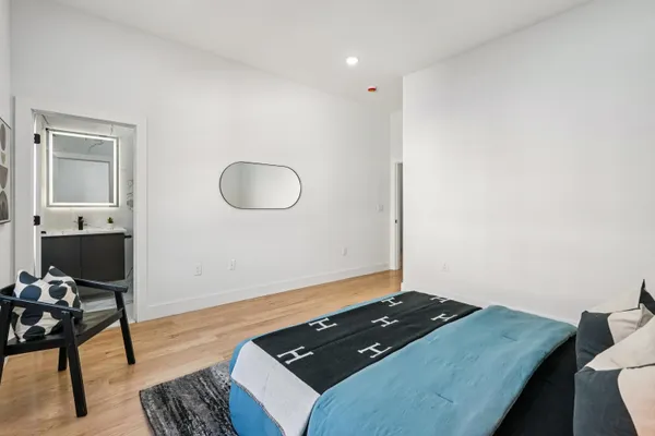 a bed sitting in a bedroom next to a window