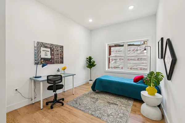 a bedroom with a bed and a chandelier