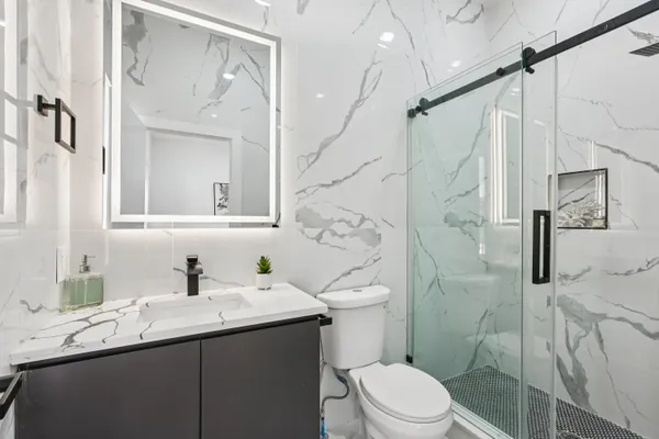 a view of bathroom with a sink and mirror