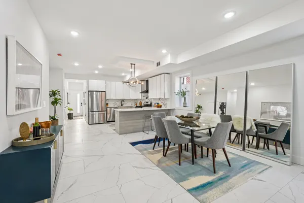 a large kitchen with a table and chairs