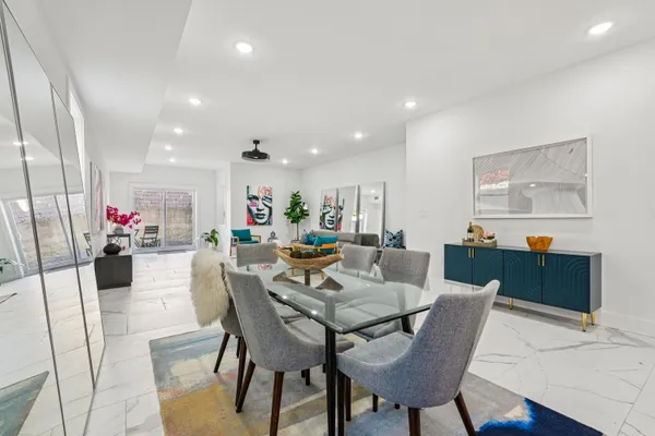 a dining room with furniture and wooden floor