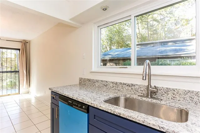 a kitchen with granite countertop a sink and a window
