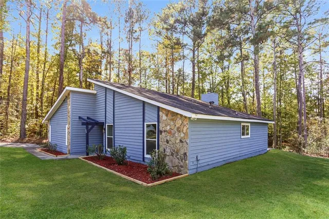 a view of a backyard with barn and large trees