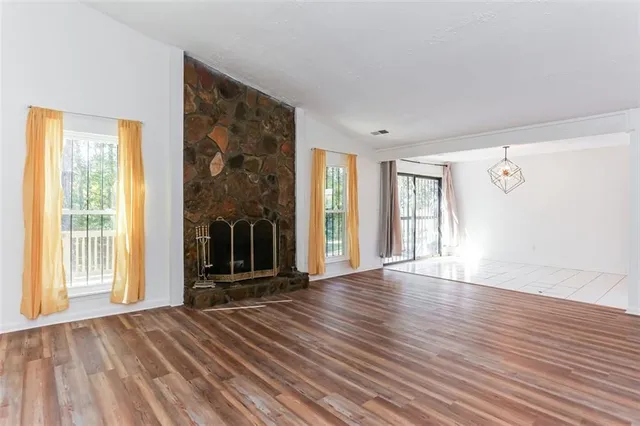 a view of a room with wooden floor and a large window