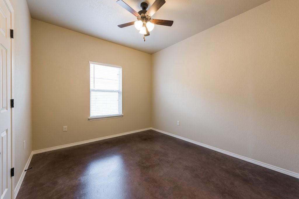 491 Jack Rabbit Lane, Unit A Buda, TX 78610 - Photo 14 of 22 An airy room awaits personalization with its durable flooring and integrated ceiling fan.