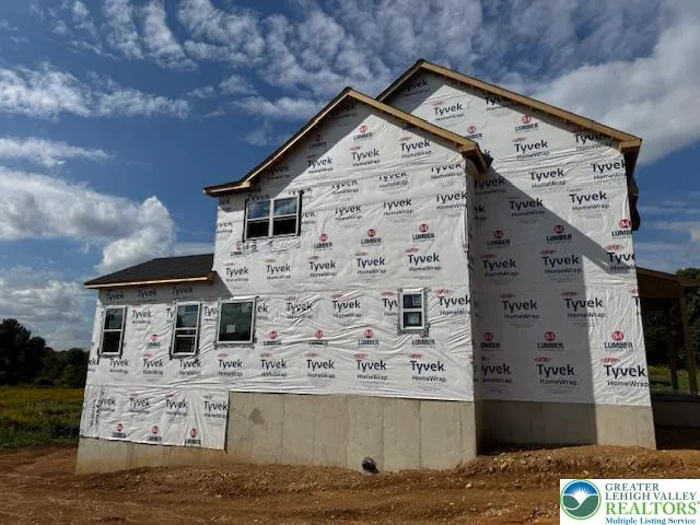 a front view of a house with mountain