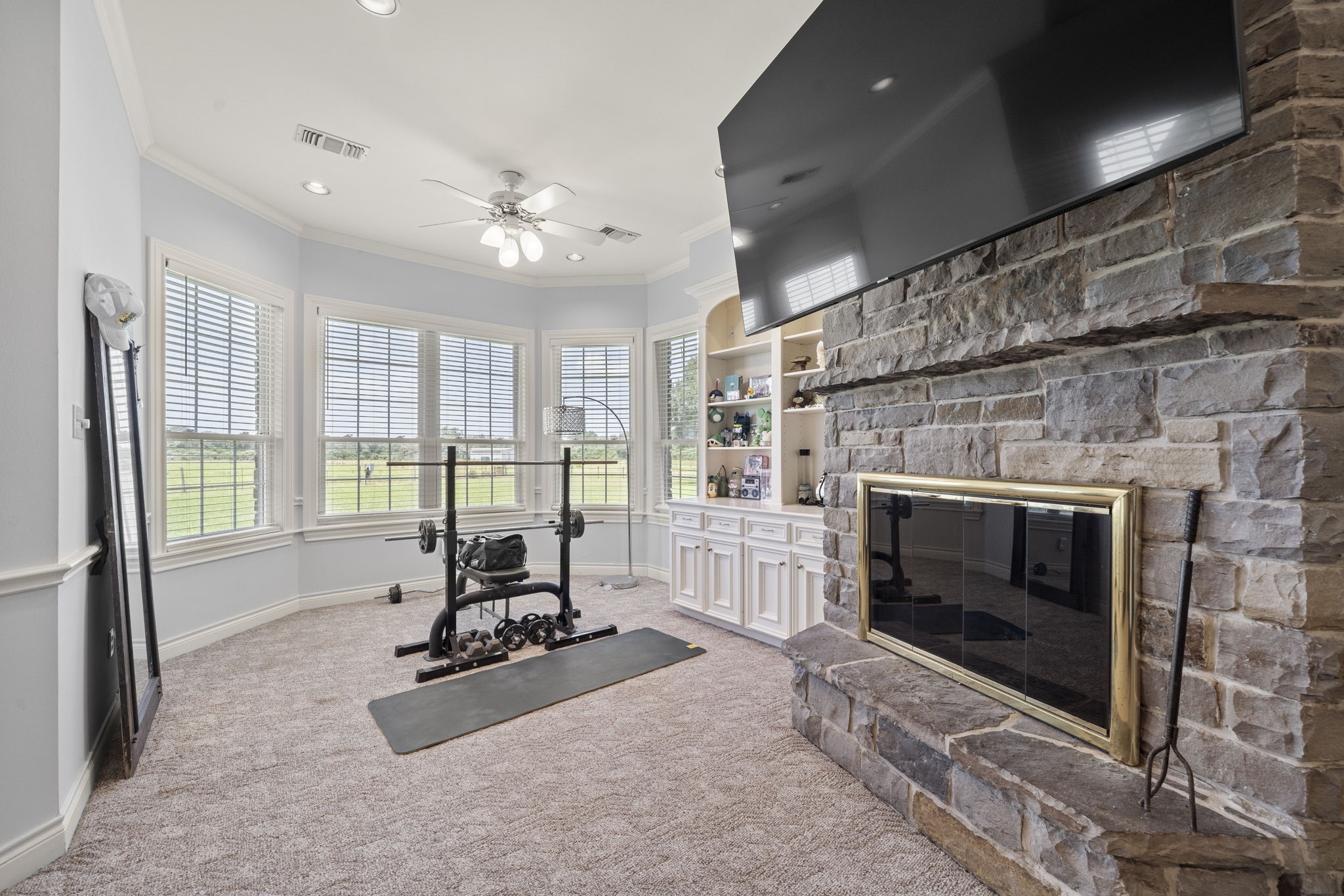 35111 Tompkins Road Hempstead, TX 77445 - Photo 17 of 50 a living room with furniture large windows and a fireplace