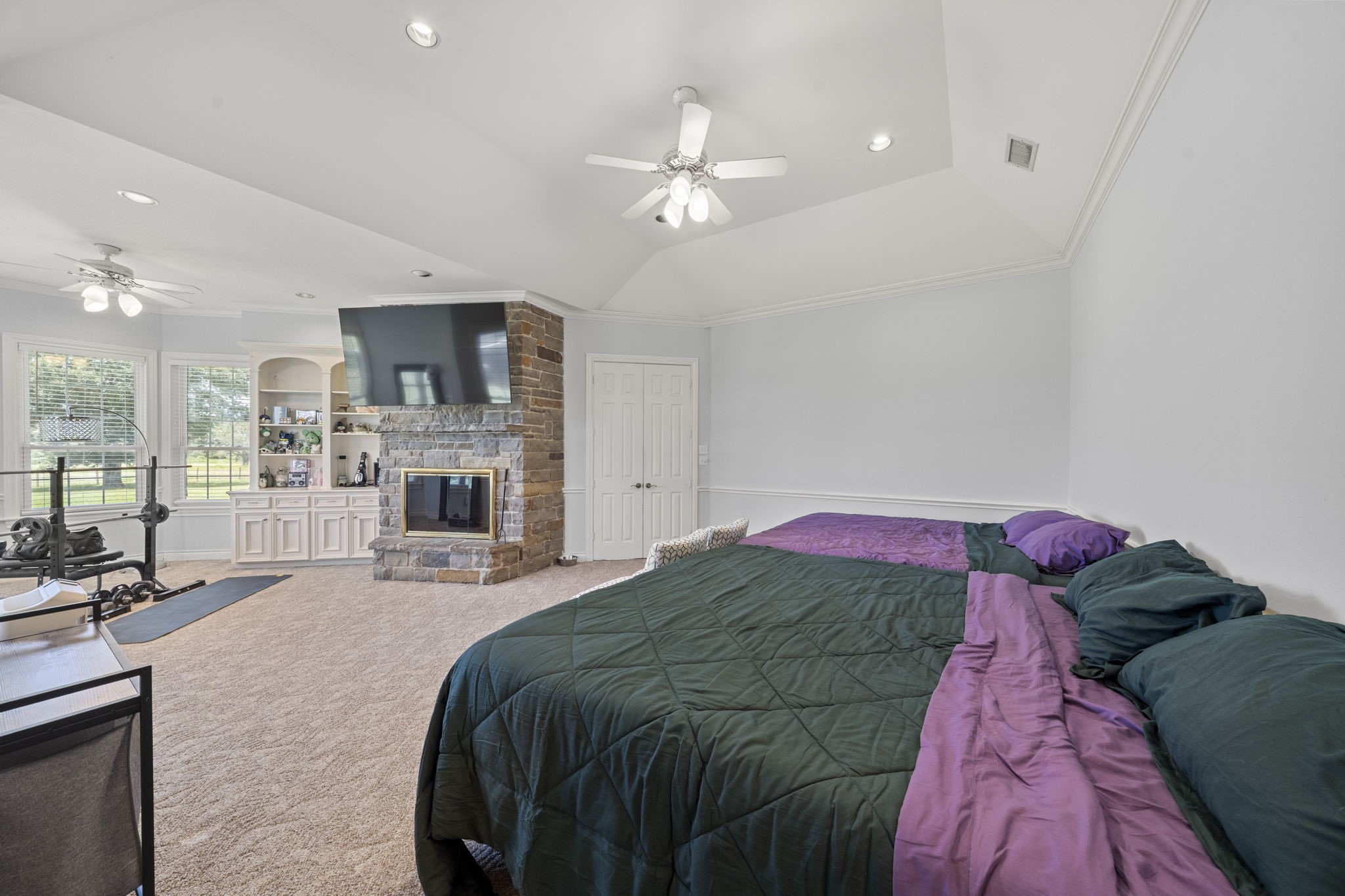 35111 Tompkins Road Hempstead, TX 77445 - Photo 18 of 50 a bedroom with a large bed and a chandelier