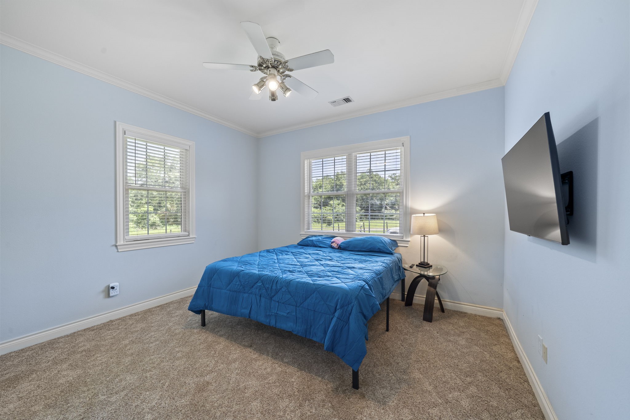 35111 Tompkins Road Hempstead, TX 77445 - Photo 22 of 50 a bedroom with a bed and a flat tv screen on dresser