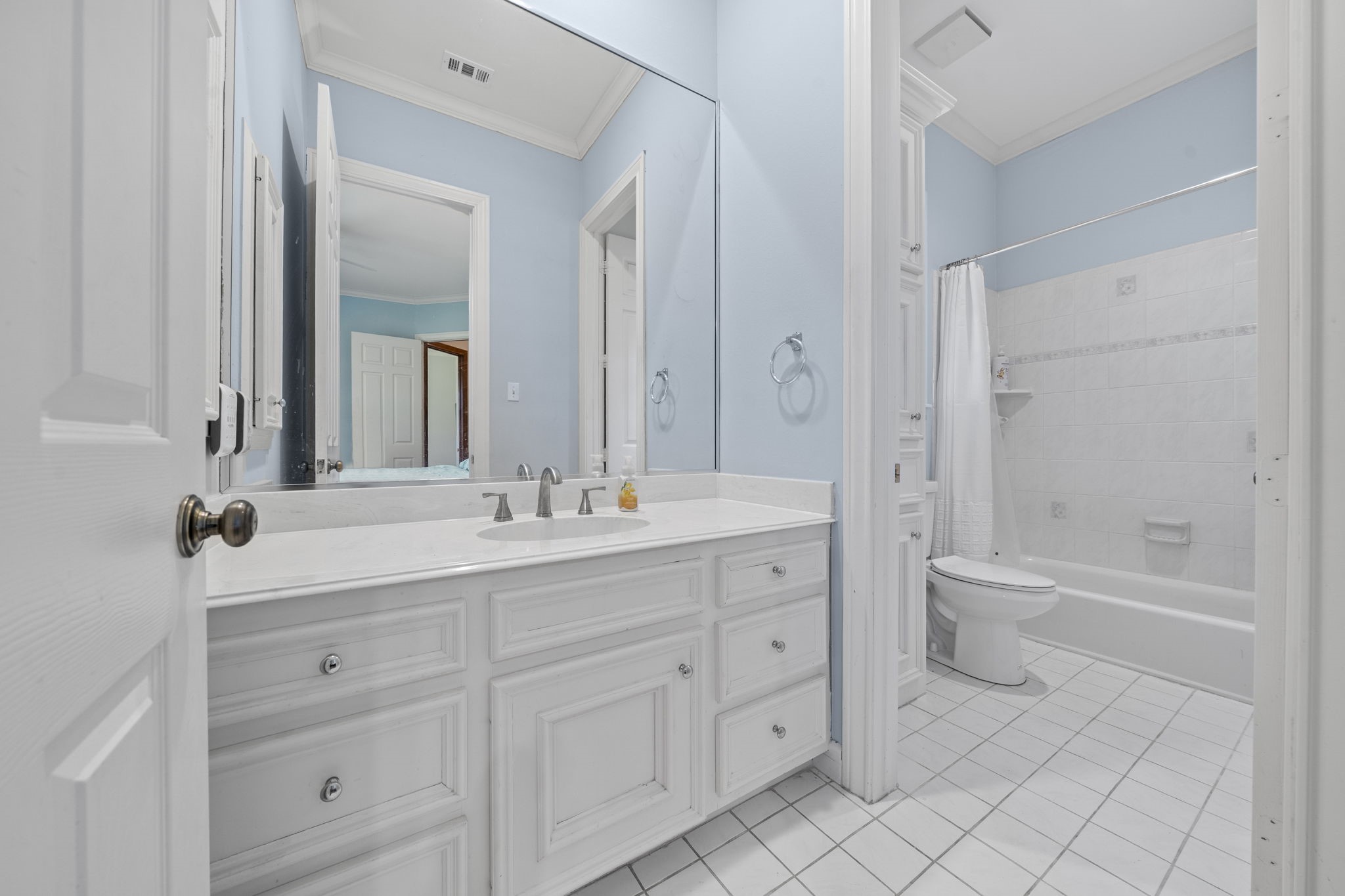 35111 Tompkins Road Hempstead, TX 77445 - Photo 24 of 50 a bathroom with a granite countertop toilet a double vanity sink a mirror and a bathtub