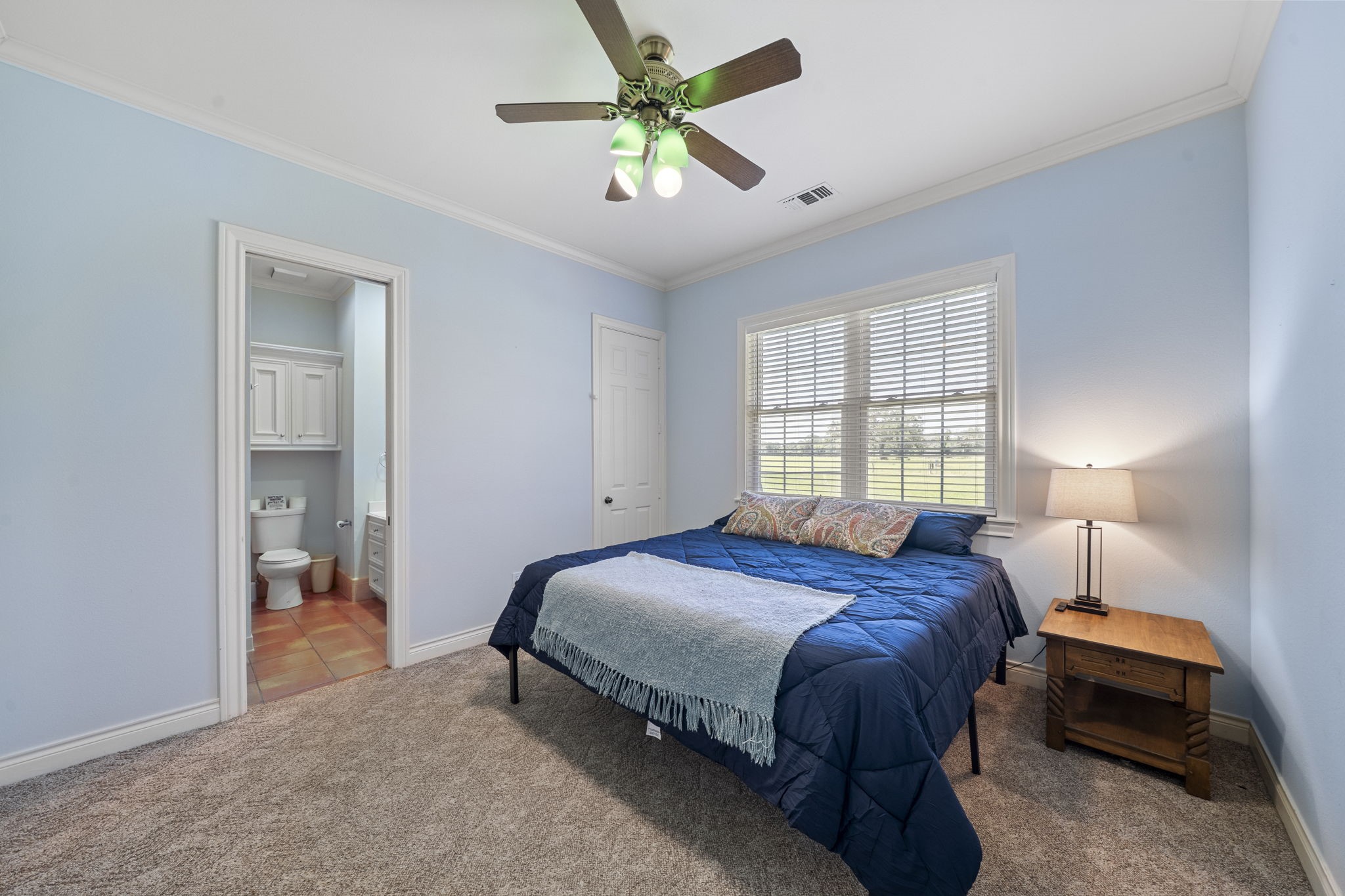 35111 Tompkins Road Hempstead, TX 77445 - Photo 26 of 50 a bedroom with a bed and a chandelier