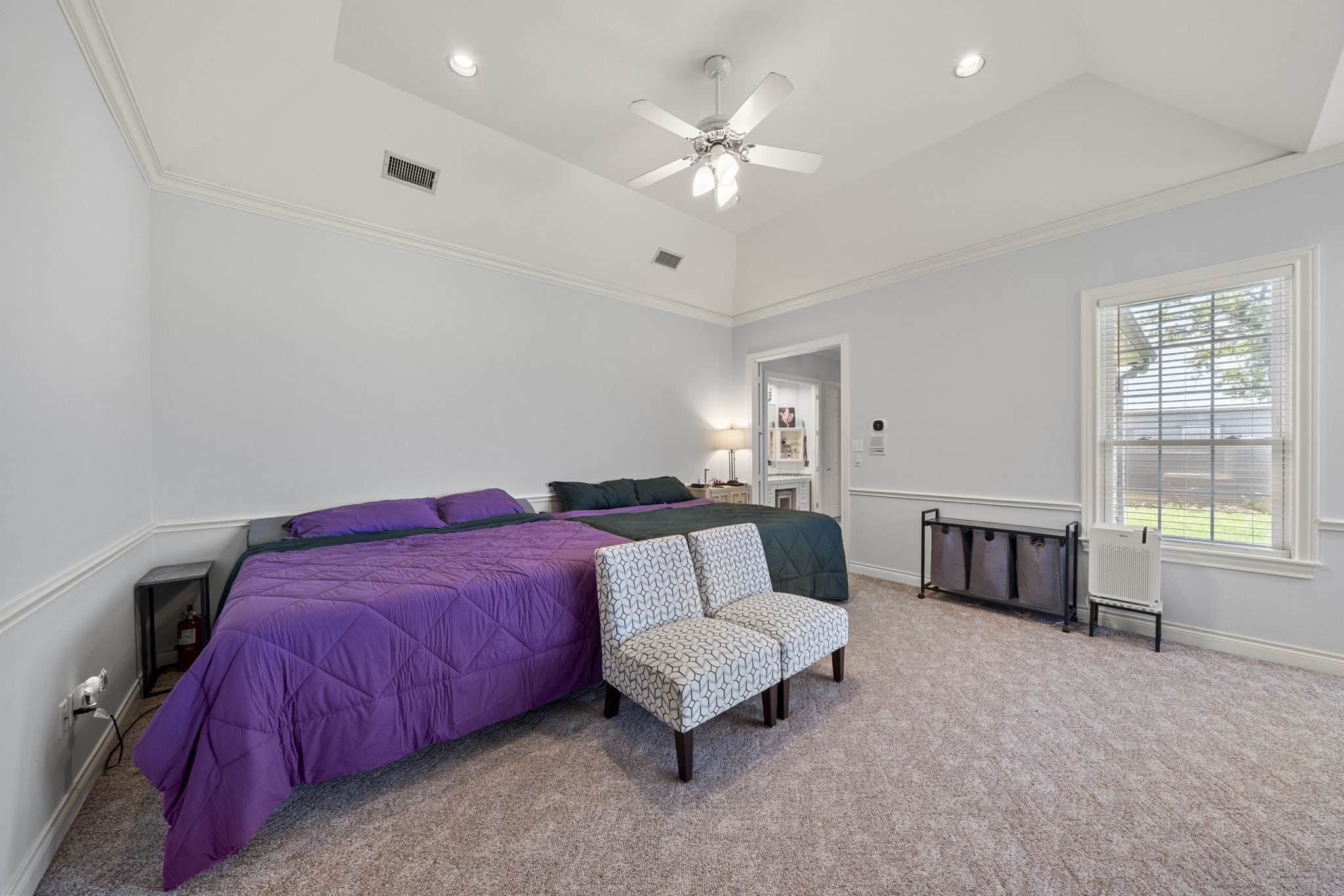 35111 Tompkins Road Hempstead, TX 77445 - Photo 29 of 50 a spacious bedroom with a bed a couch and a chandelier