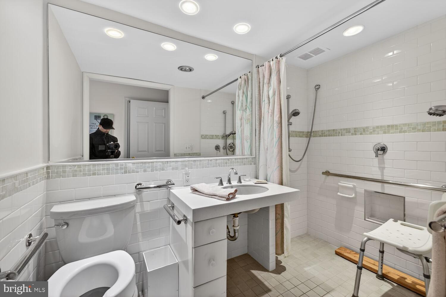 2100 Washington Avenue, Unit 6A Silver Spring, MD 20910 - Photo 9 of 16 a bathroom with a toilet sink and mirror