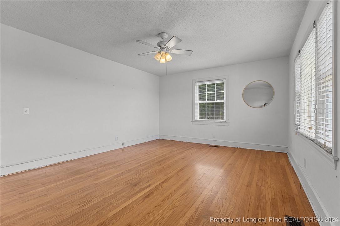 430 Simmons Road Clinton, NC 28328 - Photo 4 of 30 a view of empty room with wooden floor and fan