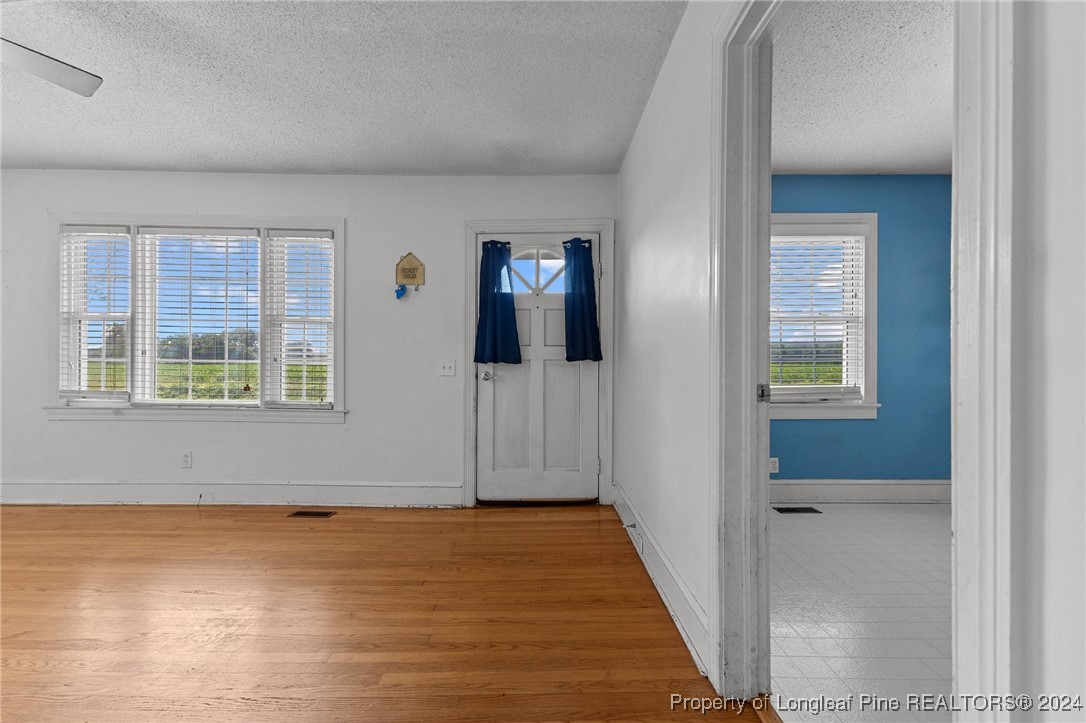 430 Simmons Road Clinton, NC 28328 - Photo 6 of 30 a view of an empty room with wooden floor and a window
