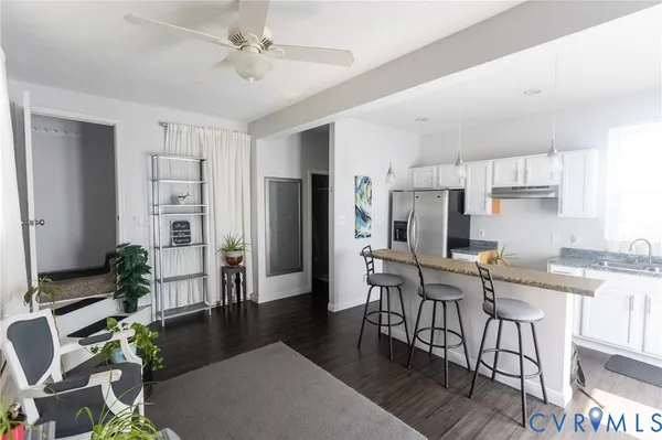 a kitchen with furniture wooden floor and a refrigerator