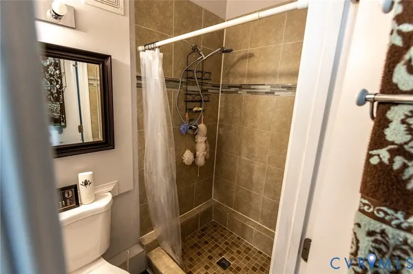 a bathroom with a shower toilet and sink