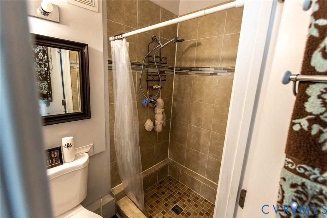 3213 Drawbridge Court Chesapeake, VA 23323 - Photo 17 of 20 a bathroom with a shower toilet and sink