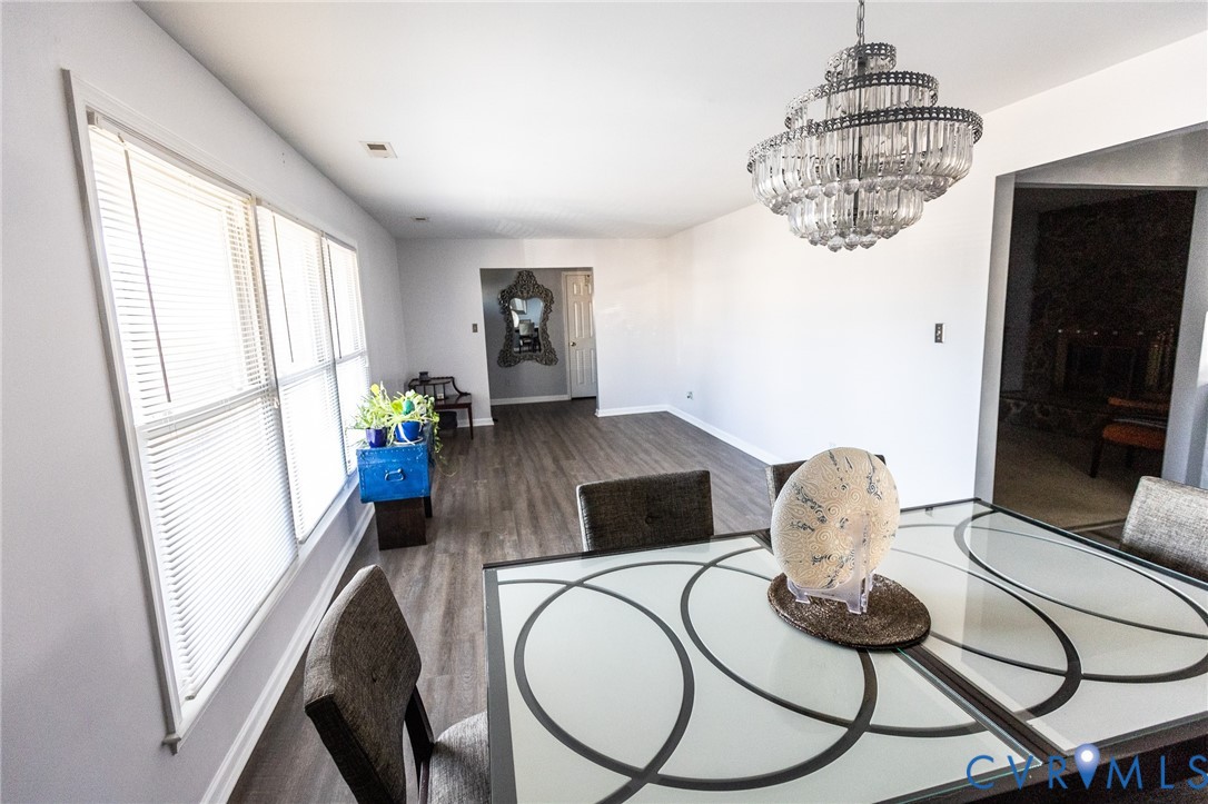3213 Drawbridge Court Chesapeake, VA 23323 - Photo 3 of 20 a living room with furniture a chandelier and a flat screen tv