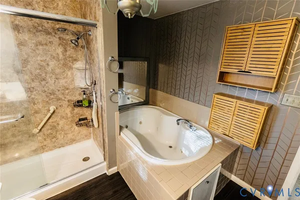 a bathroom with a bathtub and shower