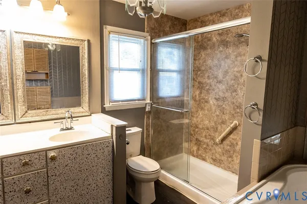 a bathroom with a sink toilet and shower