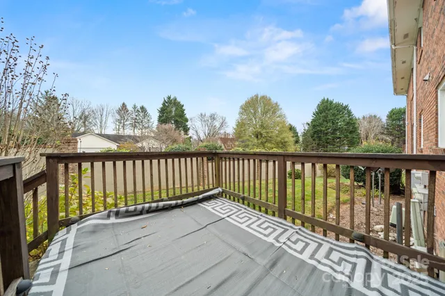 a balcony with wooden floor and fence