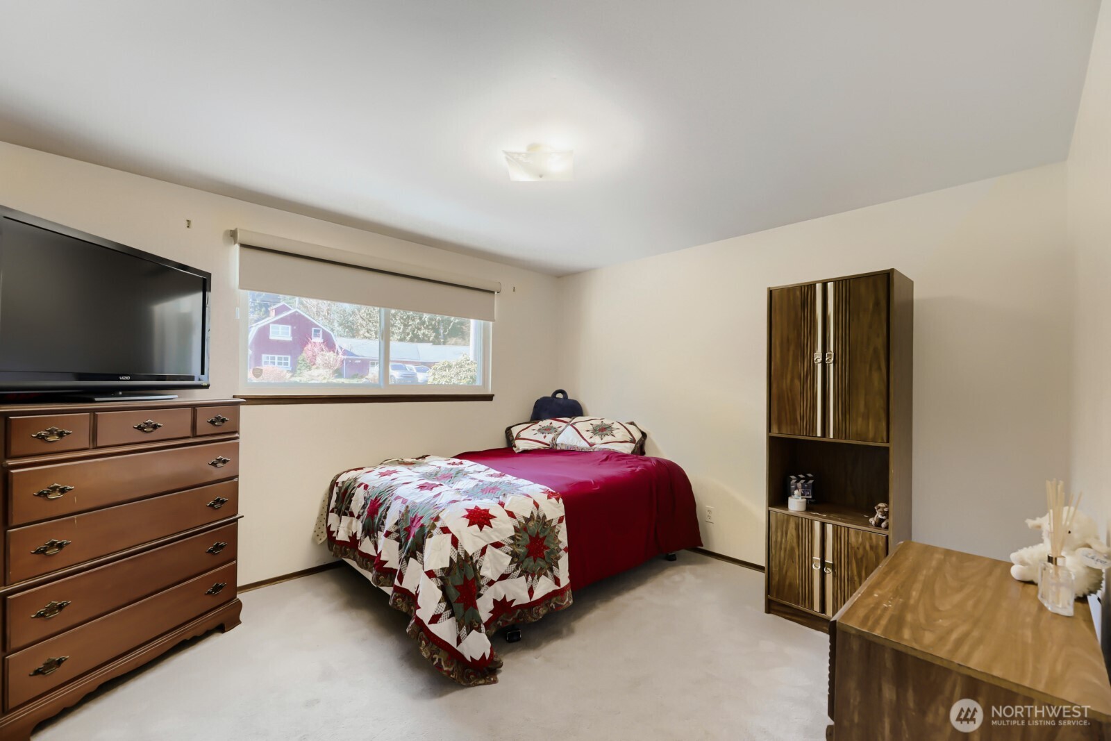 24119 78th Place West Edmonds, WA 98026 - Photo 21 of 29 a bedroom with a bed and a flat tv screen on dresser