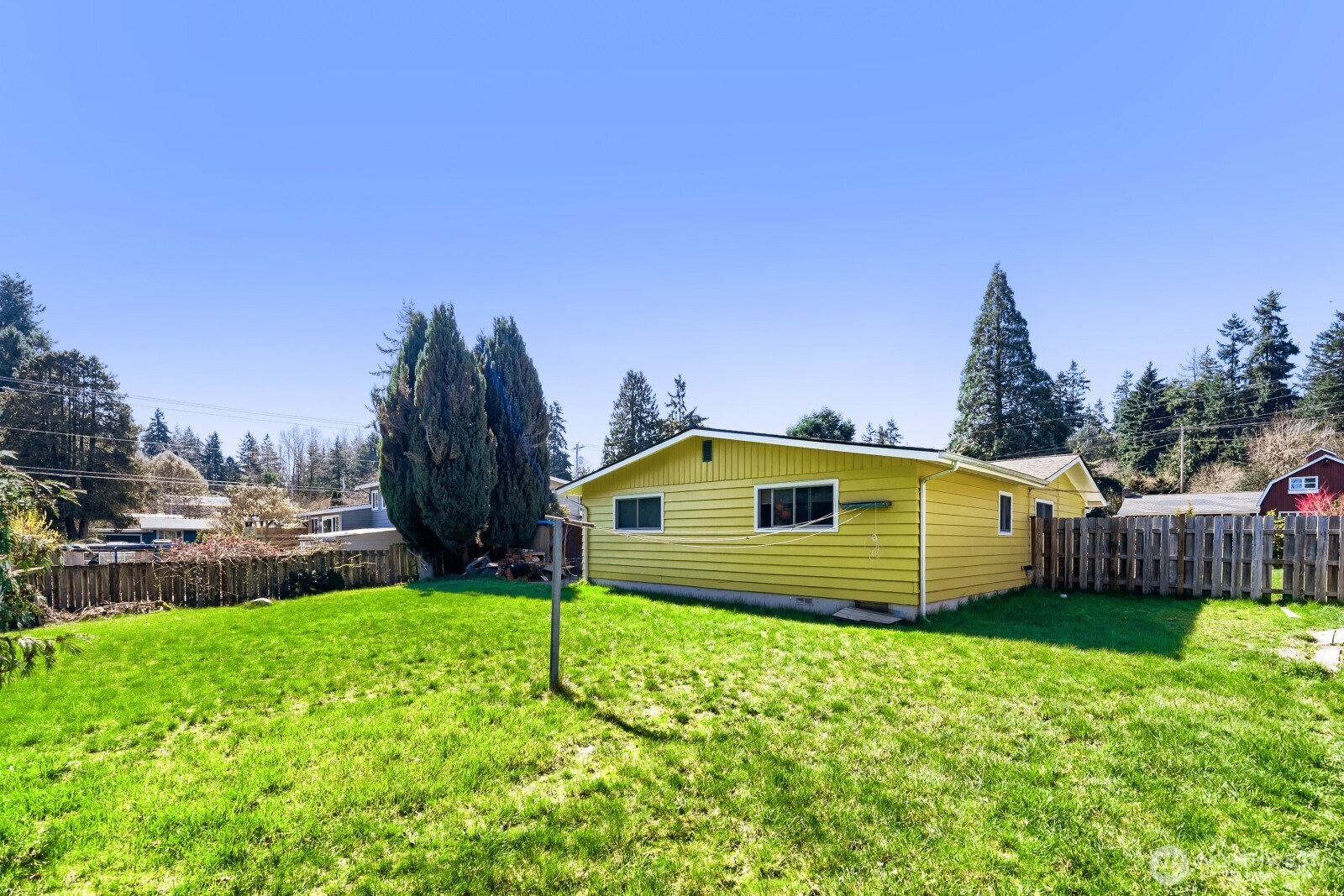 24119 78th Place West Edmonds, WA 98026 - Photo 28 of 29 a yellow house sitting in middle of the grass and a yard