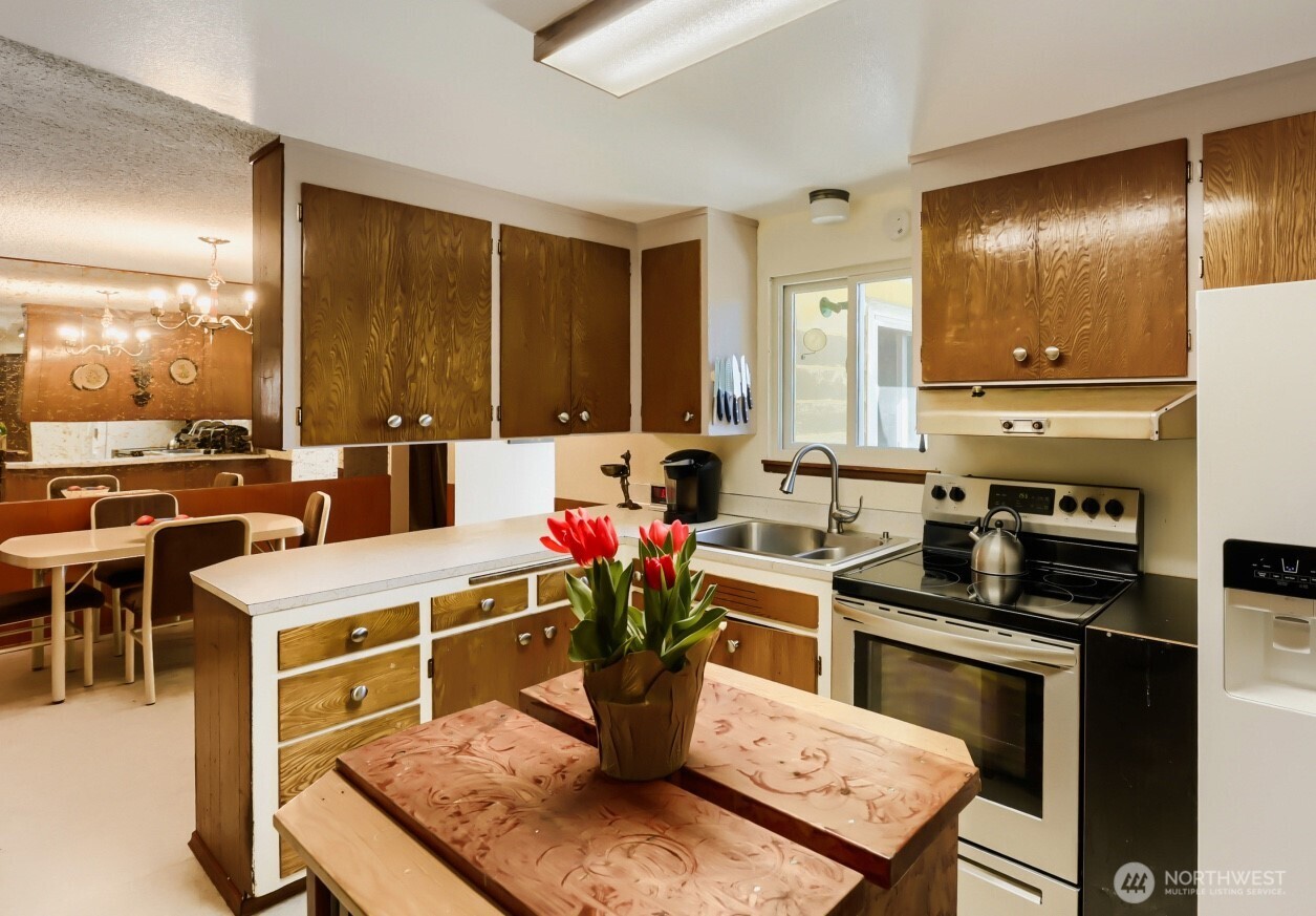 24119 78th Place West Edmonds, WA 98026 - Photo 10 of 29 a kitchen with a stove refrigerator and cabinets
