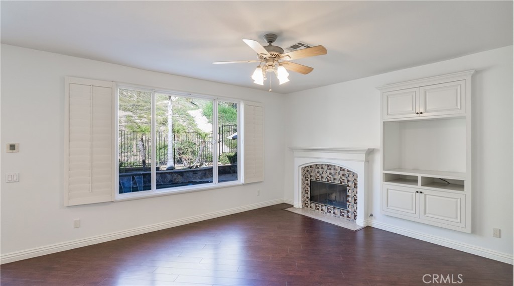 2827 Arbella Lane Thousand Oaks, CA 91362 - Photo 11 of 48 a view of a livingroom with wooden floor a ceiling fan and windows