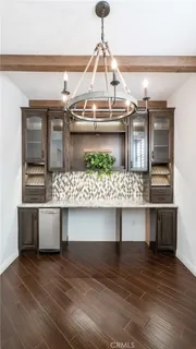 a view of room with wooden floor and seating space