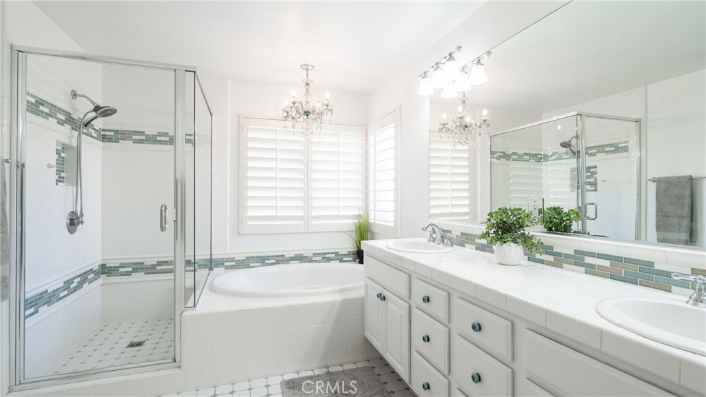 2827 Arbella Lane Thousand Oaks, CA 91362 - Photo 22 of 48 a spacious bathroom with double vanity a window a large mirror and a bathtub