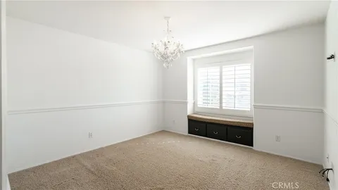 an empty room with a window and a ceiling fan